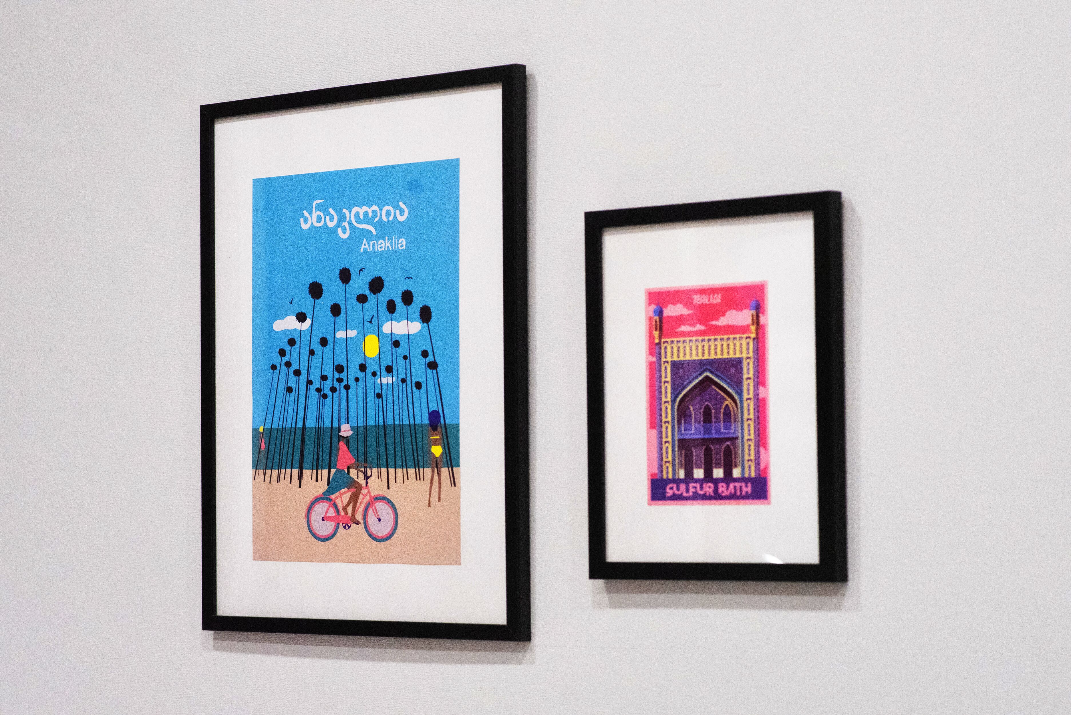 Two framed artworks on a wall.