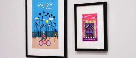 Two framed artworks on a wall.