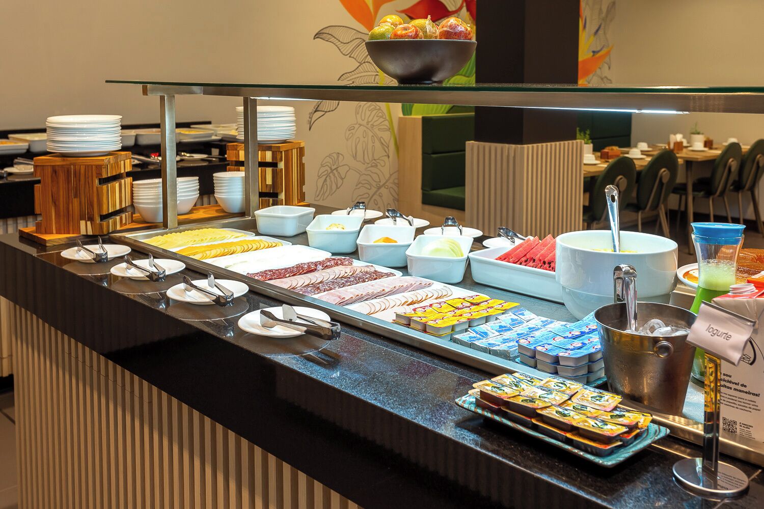 A buffet with various food items and utensils.