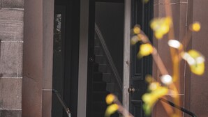 A building entrance with a set of stairs leading up to a door. - Spacious 4 Bedroom Flat in Stirling (Stirling)