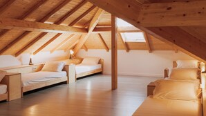 A spacious attic bedroom with wooden beams, two single beds, and a skylight. - Quinta da Quinhas (Caminha)