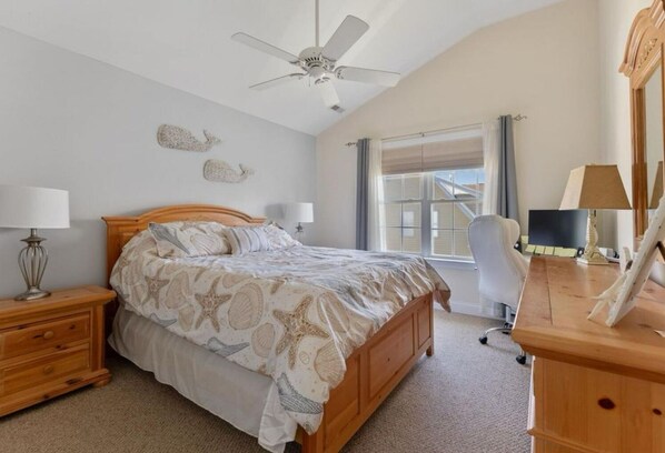 A bedroom with a bed, nightstands, a desk, a chair, a ceiling fan, and a window with curtains. - Beautiful, 3 bed, 2 bath, Cozy Condo just minutes from Boardwalk & Beach Access! (Wildwood)