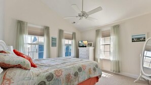 A bedroom with a bed, a ceiling fan, a dresser, and a window with curtains. - Beautiful, 3 bed, 2 bath, Cozy Condo just minutes from Boardwalk & Beach Access! (Wildwood)