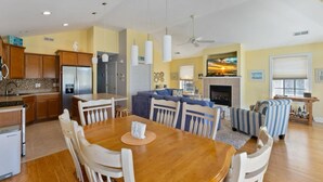 A spacious living area with a dining table, sofas, and a fireplace. - Beautiful, 3 bed, 2 bath, Cozy Condo just minutes from Boardwalk & Beach Access! (Wildwood)
