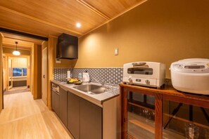 A compact kitchen with a microwave, toaster, and sink. - Hiyori Gojo (Kyoto)