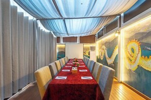 A conference room with a long table, chairs, and a red tablecloth. - Hotel Kutumba (Lalitpur)