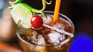 A glass with ice cubes, a lime slice, a cherry, and a straw. - Hotel Kutumba (Lalitpur)