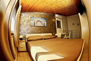A bedroom with a bed, nightstands, a painting, and a wooden ceiling. - In the Center of Castelmola one of the most beautiful villages in Italy A Casitta Da Mola (Castelmola)