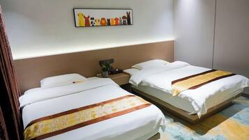 A hotel room with two beds, a nightstand, a wall-mounted artwork, and a patterned carpet.