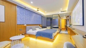 A modern hotel room with a bed, bedside tables, a seating area, and a large window. - Jianlang Holiday Hot Spring Hotel (Shilin)