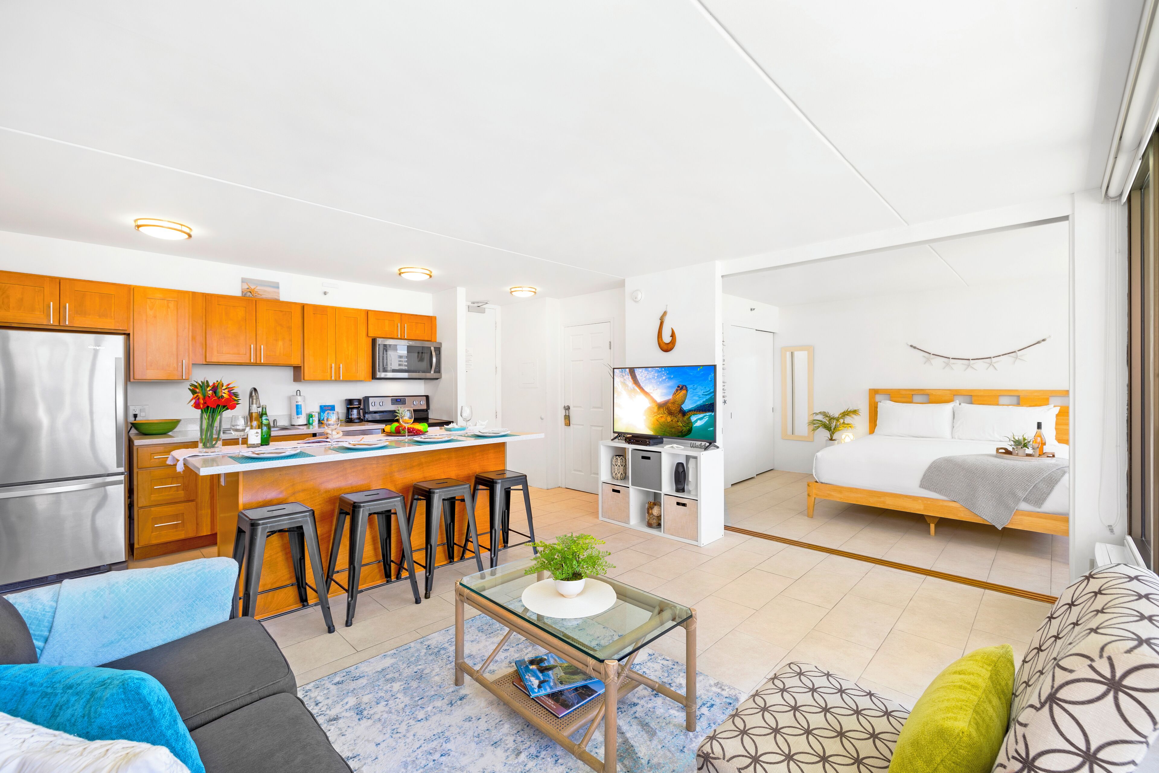 A modern apartment with a kitchen, dining area, living room, and bedroom.
