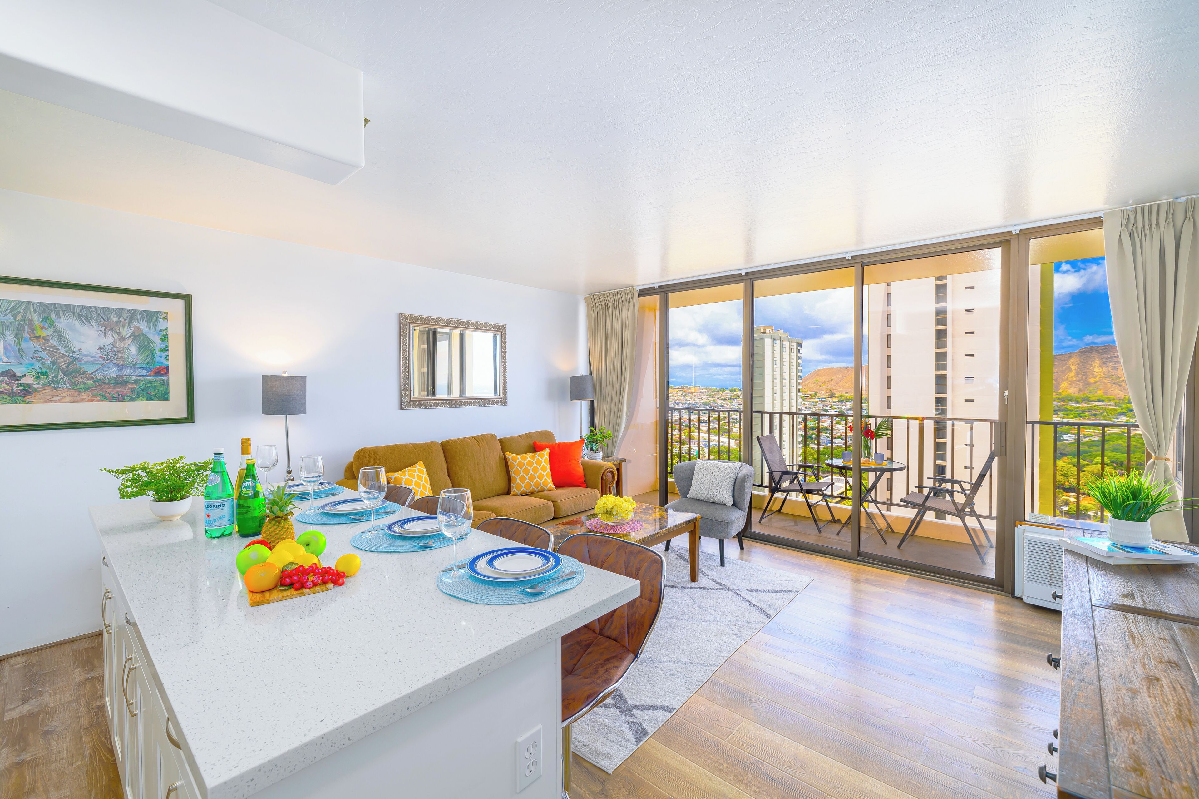 A modern living room with a dining area, large windows, and a balcony with a city view.