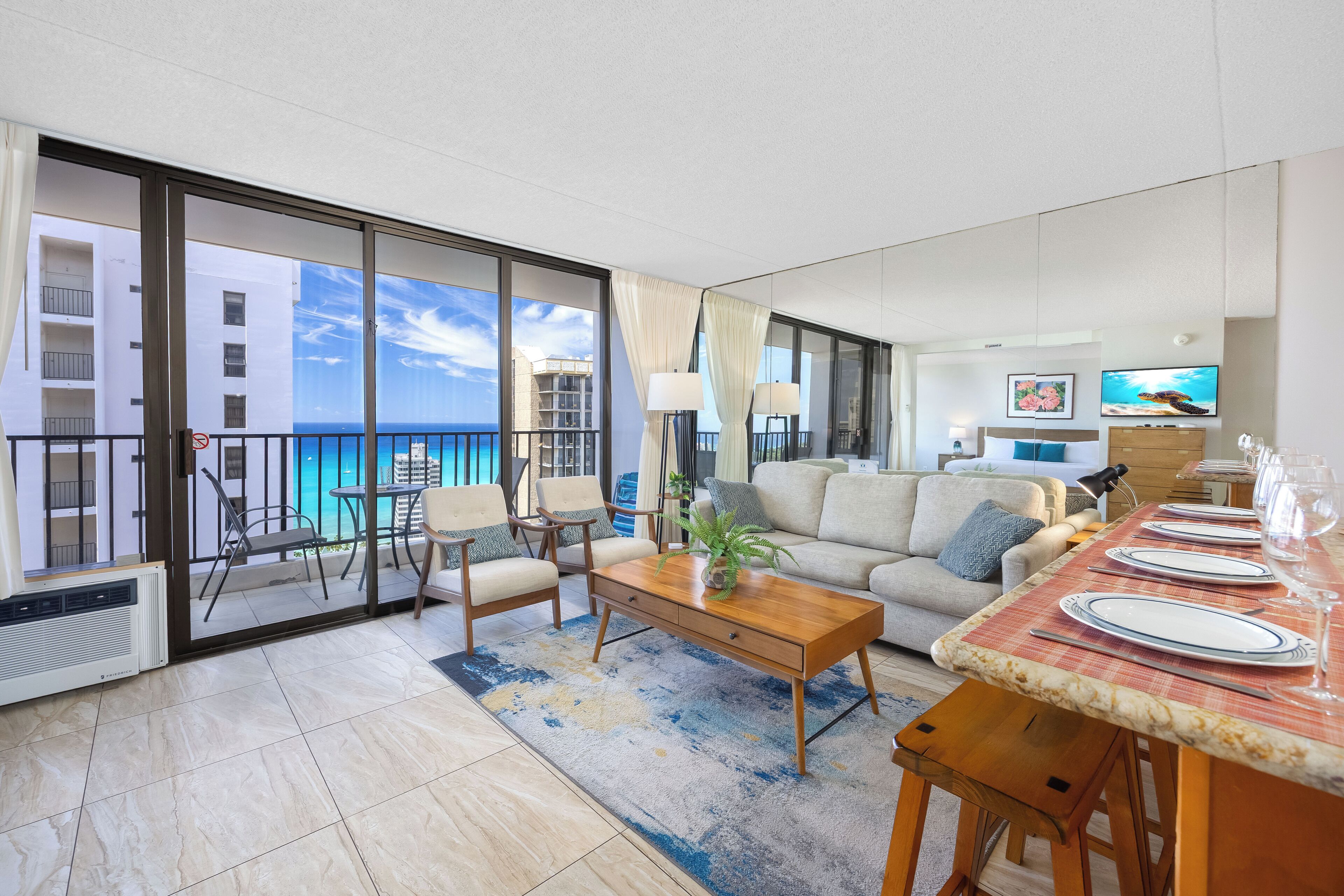A modern living room with a balcony, a dining area with a table set for four, and a sofa.