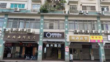 A multi-story building with various storefronts, including a hotel and a restaurant.