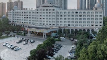 A multi-story hotel with a central courtyard, surrounded by high-rise buildings.