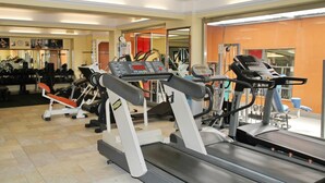 A gym with treadmills, weight machines, and exercise equipment.