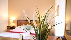 A hotel room with a bed, a bedside table, a lamp, and a mirror. - Tenuta Piana 1: Direct Access to the sea (Caronia)