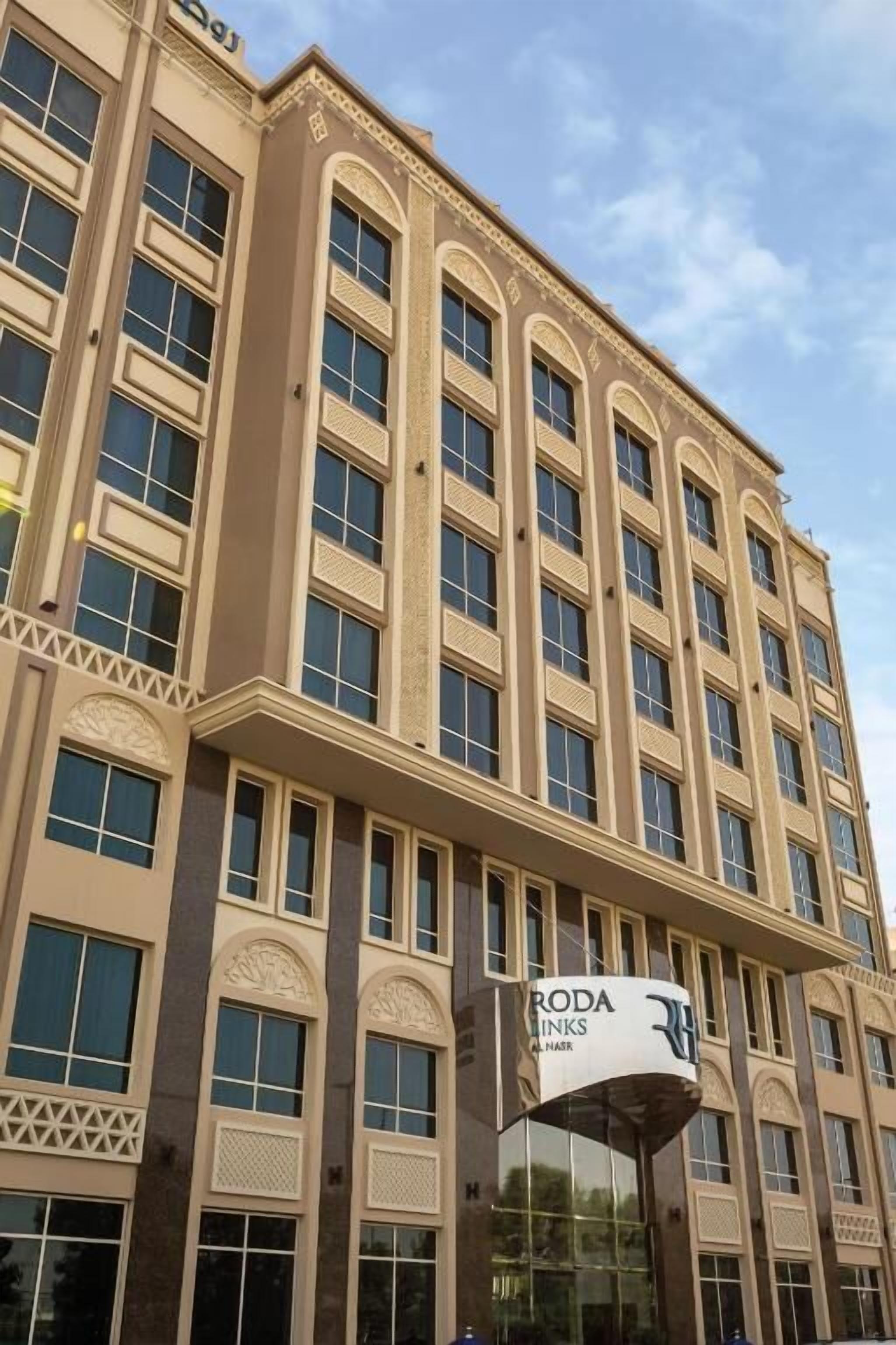 A multi-story building with a sign for "RODA INKS" on the facade.