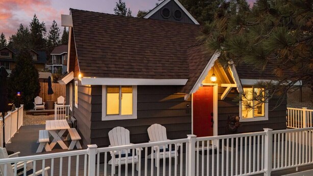 A cabin with a deck, a red door, and a white railing. - Blissful Bay Cabin + Block from Boulder Bay (Big Bear Lake)
