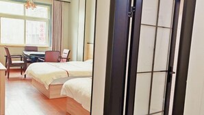 Une chambre d’hôtel avec un lit, un bureau et une chaise.