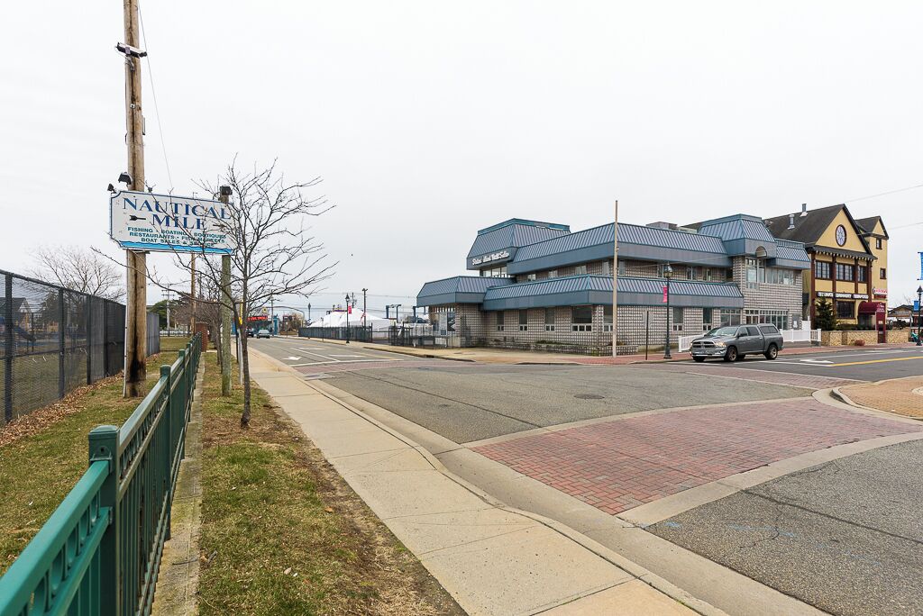 A nautical-themed building with a sign indicating it offers fishing, boating, and a restaurant.