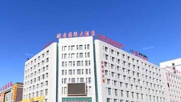 A multi-story hotel with a flat facade, large windows, and signage indicating it is a business hotel.