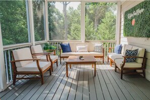 A sunlit wooden deck with a sofa, two armchairs, and a coffee table. - The Southern Peach Mansion - Entire Home in the Heart of Atlanta, GA (Atlanta)