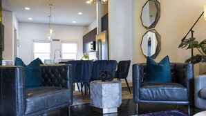 A modern living room with leather sofas, a marble coffee table, and a colorful rug. - Nashvilla Townhome- Gigantic Rooftop- Pure Luxury (Nashville)