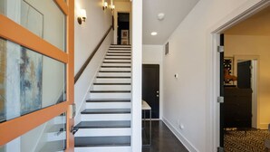 A staircase with a modern design, leading to a room with a patterned carpet. - Nashvilla Townhome- Gigantic Rooftop- Pure Luxury (Nashville)