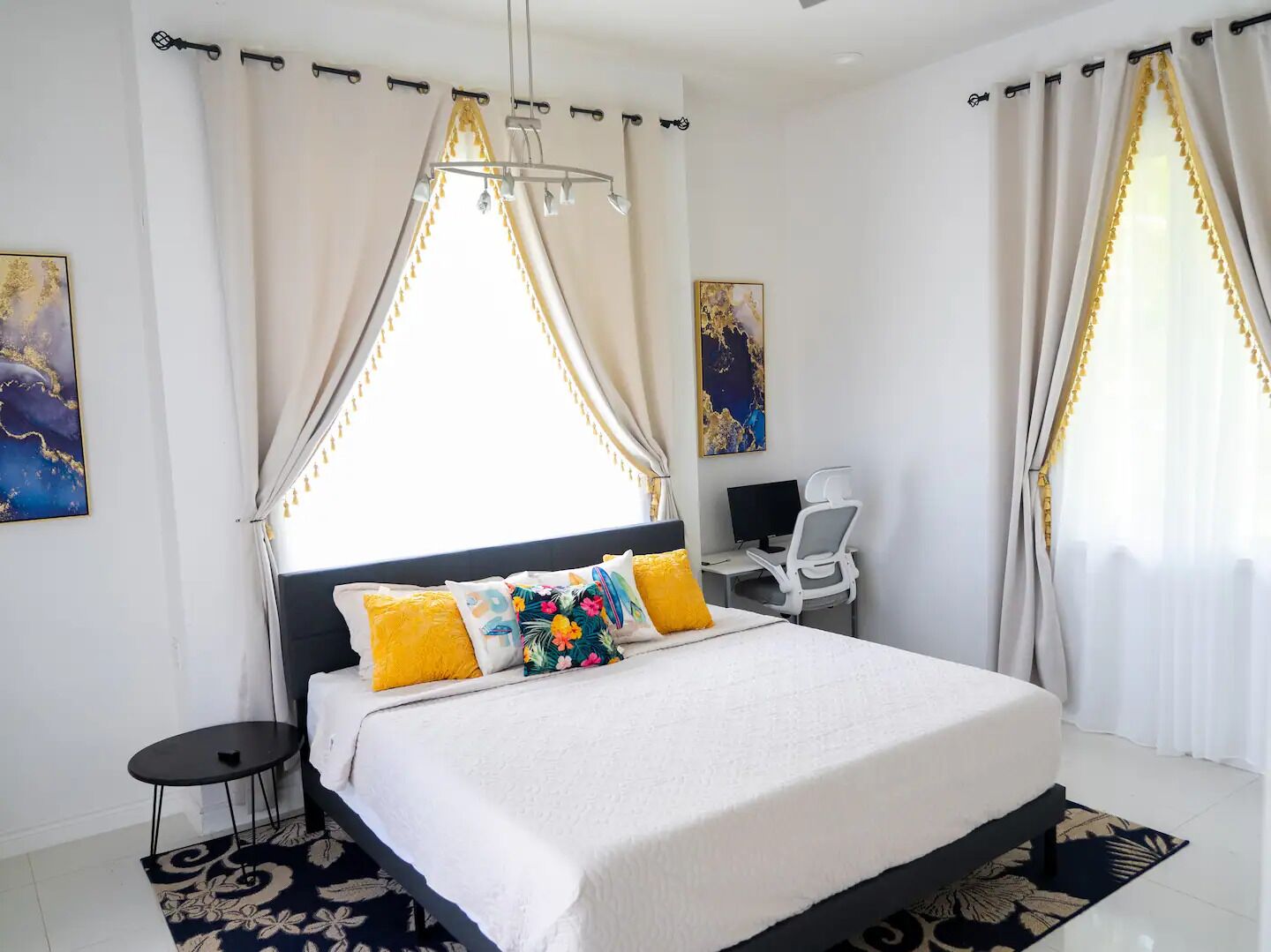A bedroom with a bed, a desk, and a chair.