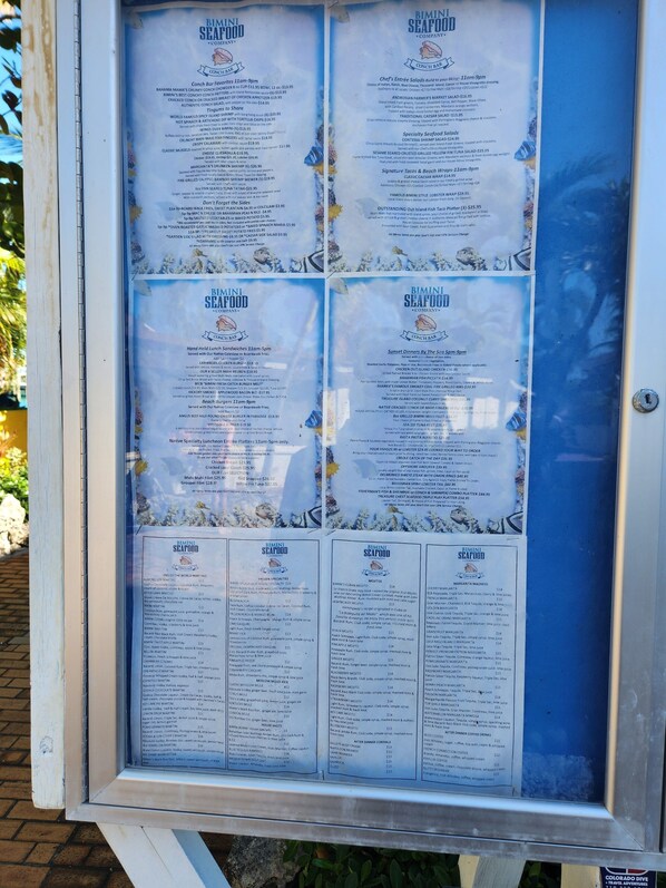 A menu board for Bimini Seafood Company, detailing various dishes and prices.