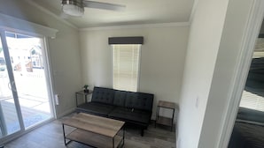 A modern living room with a sofa, coffee table, and two side tables. - Cherokee Lake Cozy Cabin in Cherokee Landing (Lakeview)