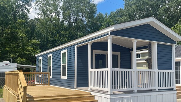 A small, single-story house with a porch and a wooden deck. - Cherokee Lake Cozy Cabin in Cherokee Landing (Lakeview)