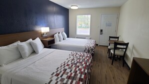 A hotel room with two beds, a desk, and a chair. - Red Roof Inn Byron (Byron)