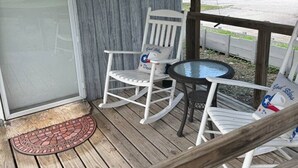 A covered porch with two rocking chairs and a small table. - Casita on the Ranch-wildlife,sunsets, stars, relax (Spring Branch)