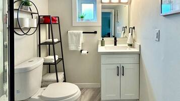 Shower, hair dryer, towels, shampoo