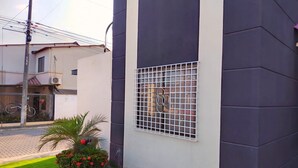 A modern building with a large window featuring a metal grid. - Cozy, secure and private suite  (Guayaquil)