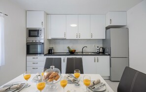 Een koelkast, een oven, een kookplaat, een vaatwasser