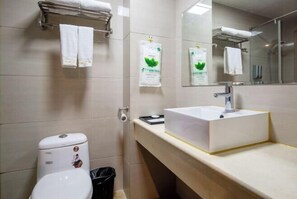 A modern bathroom with a white toilet, a sink with a mirror above it, and a towel rack with two towels. - Boerman Hotel (Chengdu Conference and Exhibition Center) (Chengdu)