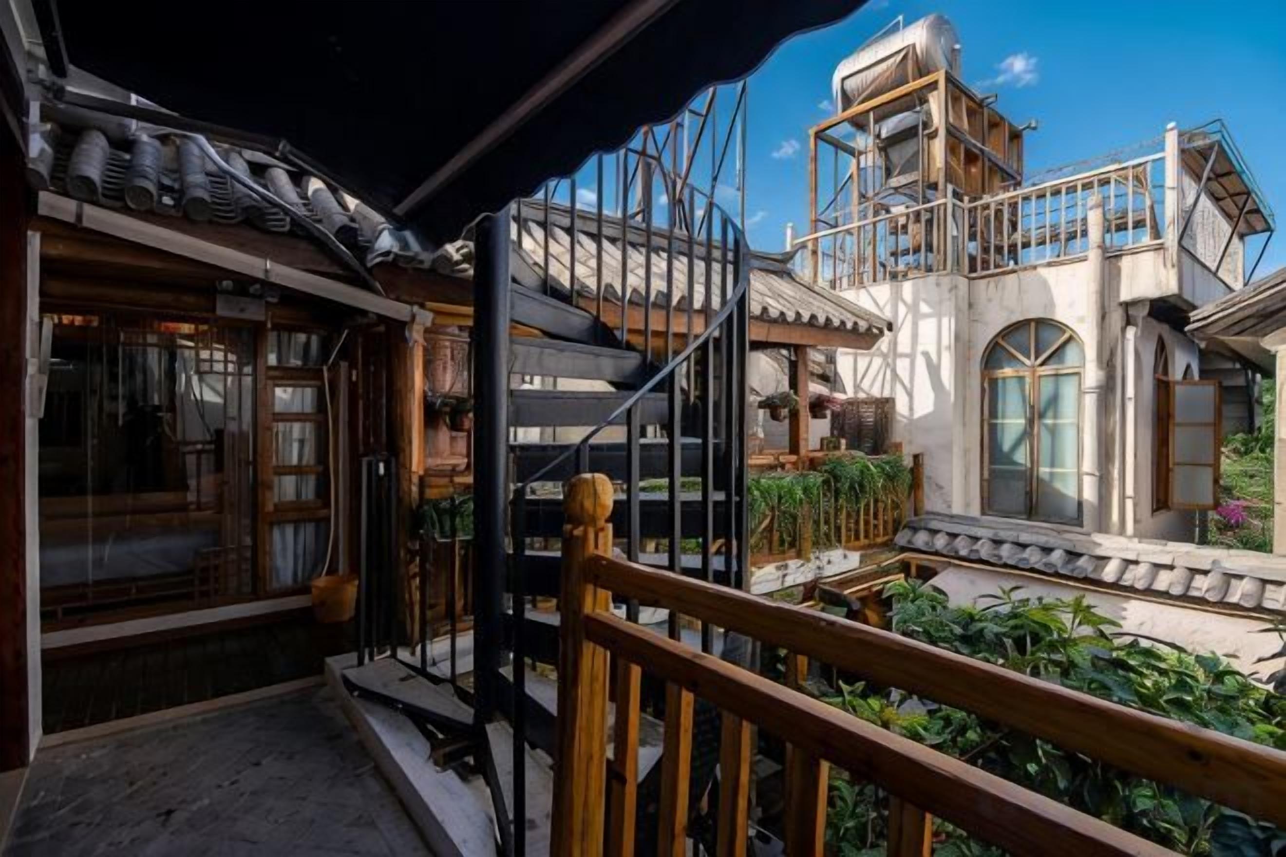 A traditional building with a balcony, wooden railings, and a staircase.