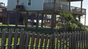 A two-story building with a balcony on the upper floor. - 3-bedroom house in charming Surfside Beach with AC, WiFi (Surfside Beach)