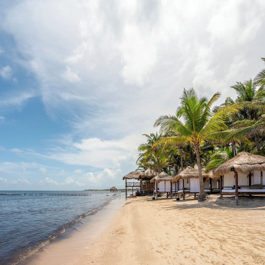 On the beach, white sand, beach umbrellas, beach towels