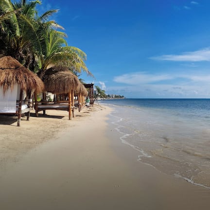 On the beach, white sand, beach umbrellas, beach towels