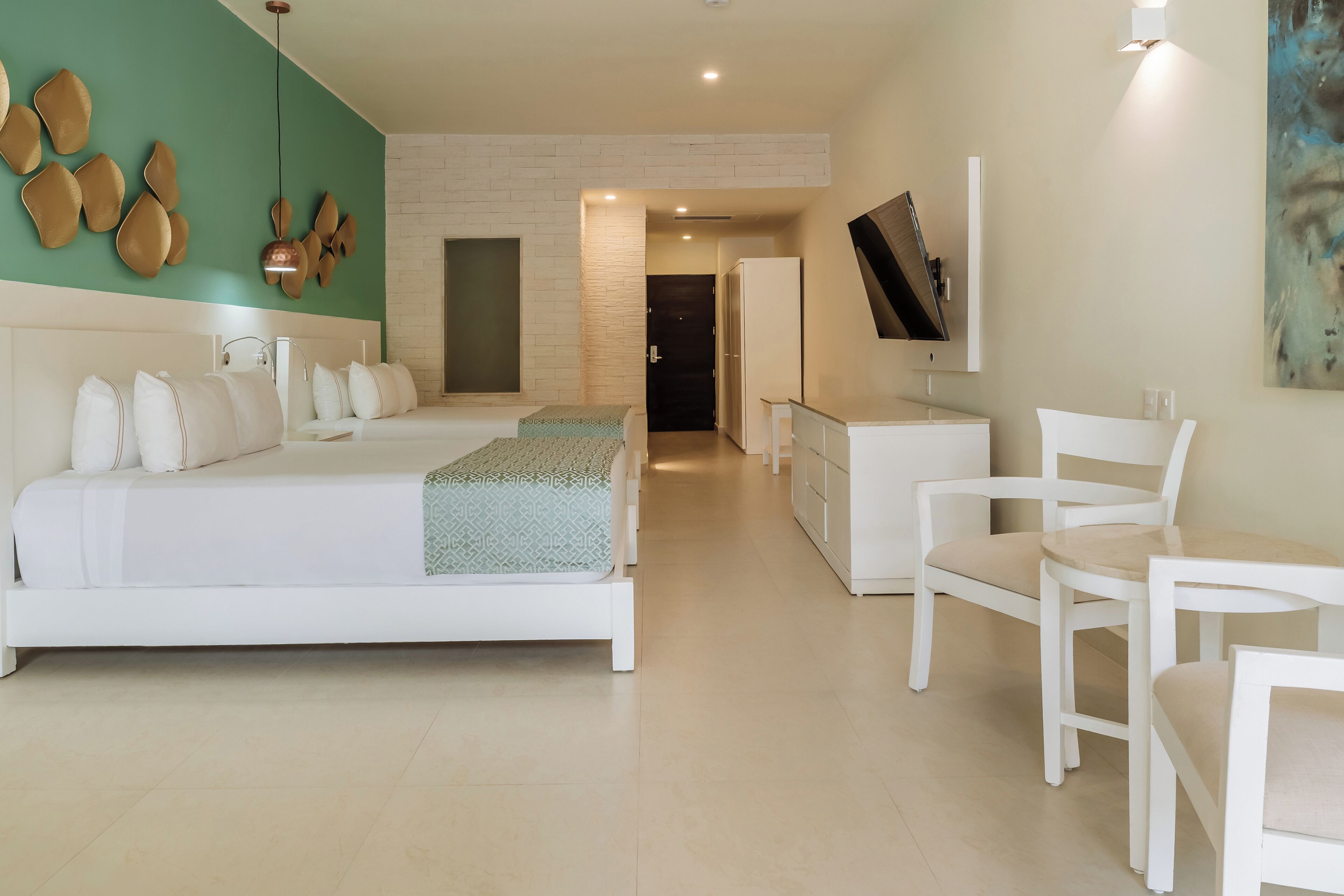 A modern bedroom with a large bed, a desk, and a chair.