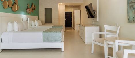 A modern bedroom with a large bed, a desk, and a chair.