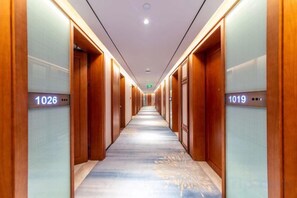 A hotel corridor with doors numbered 1026 and 1019. - Huayun Hotel (Yushan)