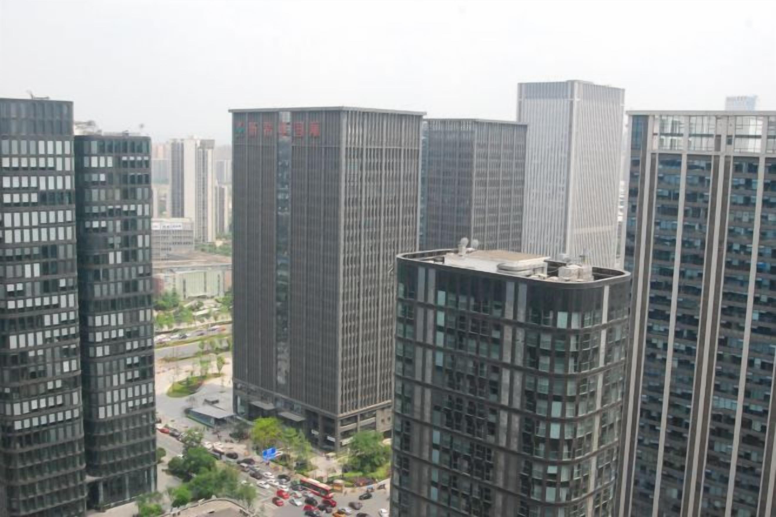 A high-rise building with a flat roof and multiple windows.