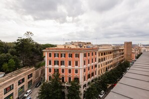 A multi-story building with a classical architectural style, featuring a central courtyard and a prominent tower. - Penthouse Brancaccio - Wide Panoramic Terrace (Roma)