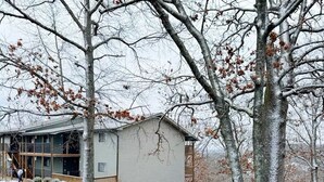 Un edificio de dos pisos con techo plano y porche cubierto.