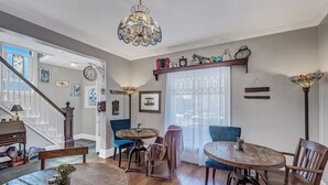 A dining area with a wooden table and chairs, a chandelier, and a staircase leading to another room. - Downtown Rustic Luxury Garden Suite (Glenwood Springs)